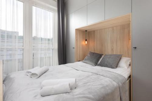 a large white bed in a room with a window at Rent like home - Marszałkowska 28 in Warsaw