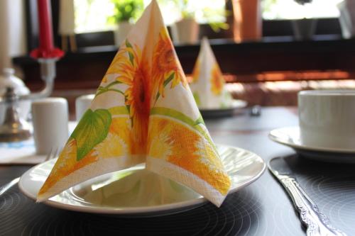 a napkin on top of a plate on a table at Hotel Grüner Baum in Stollberg