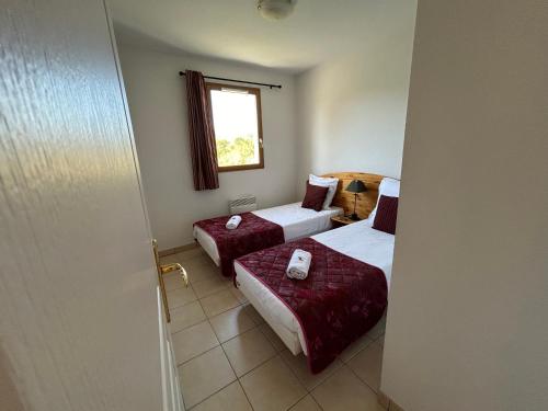 a hotel room with two beds and a window at Olydea Montbrun-les-Bains in Montbrun-les-Bains