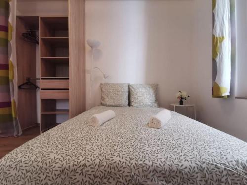 a bedroom with a bed with two pillows on it at Le repos biterrois ઼ in Béziers
