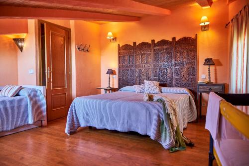 a bedroom with two beds in a room at Alojamiento Rural Fuente del Arca (Prádena del Rincón) in Prádena del Rincón