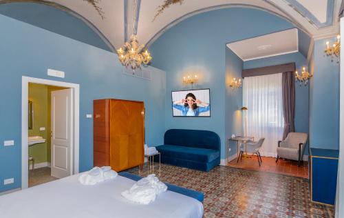a hotel room with a bed and a couch at Hotel Villa San Michele in Lucca