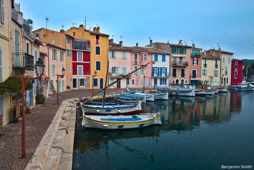 a group of boats docked in a canal with buildings at Le Havre de Ferrieres - free Parking - WiFi - Cuisine in Martigues
