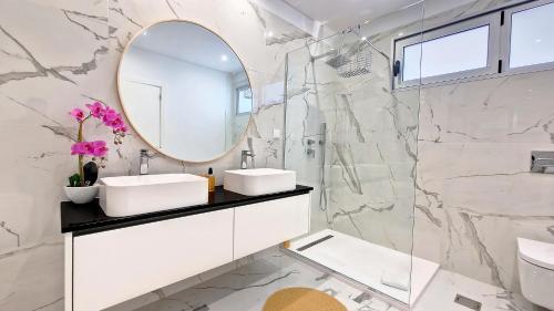 a bathroom with two sinks and a mirror at 24, The Townhouse by LovelyStay in Funchal