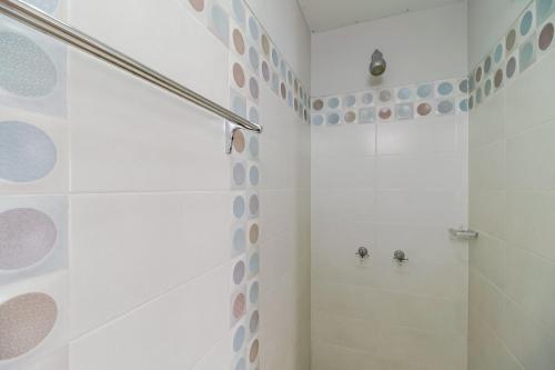 bagno bianco con doccia e servizi igienici di RedDoorz near Jam Gadang Syariah Bukit Tinggi a Bukittinggi