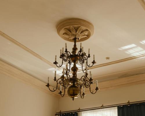 a chandelier hanging from a ceiling in a room at Hotel Pod Różą in Kraków