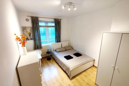a small bedroom with a bed and a large window at Central London Spacious Flat with 2 to 3 Bedrooms in London
