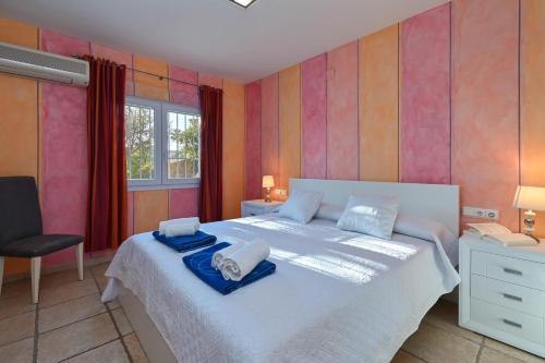 a bedroom with a large bed with towels on it at Villa Jarmila in Jávea