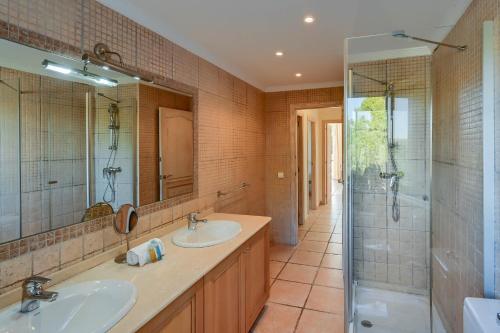 a bathroom with two sinks and a shower at Villa Jarmila in Jávea