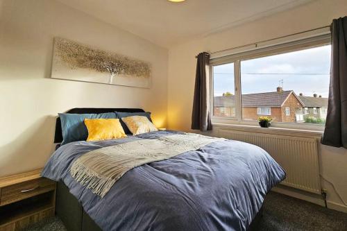 a bedroom with a bed and a large window at Little Hulton, Manchester 