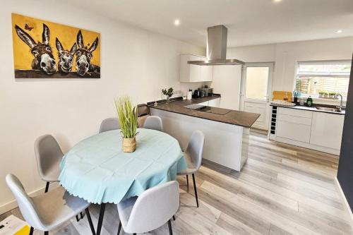 a kitchen and dining room with a table and chairs at Little Hulton, Manchester 