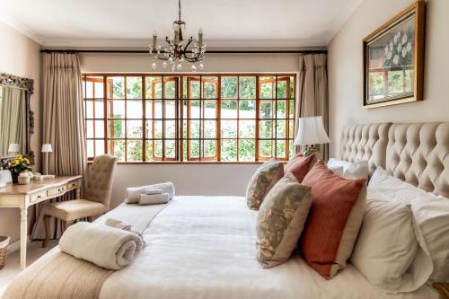 a bedroom with a large bed with a large window at Hillingdale on Alexandra in Cape Town
