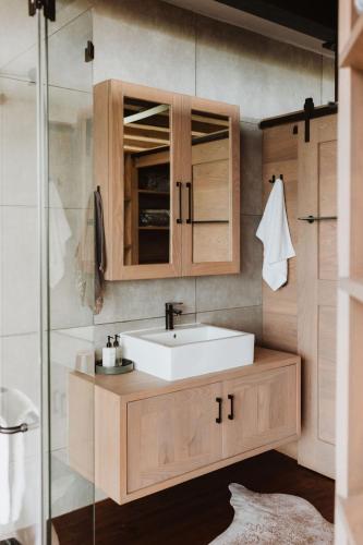 a bathroom with a sink and a glass shower at Eagle View on Beumont in Dullstroom