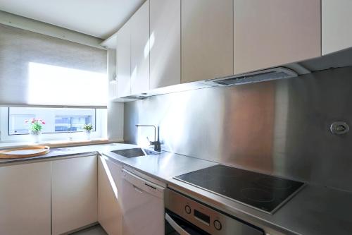 a kitchen with a sink and a stove top oven at HM - Ocean Breeze Delight in Matosinhos