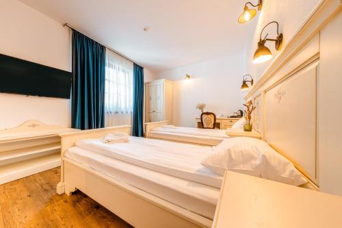 two beds in a room with a window at CASA CHITIC - HOTEL & RESTAURANT- Str Nicolae Balcescu 13 in Braşov