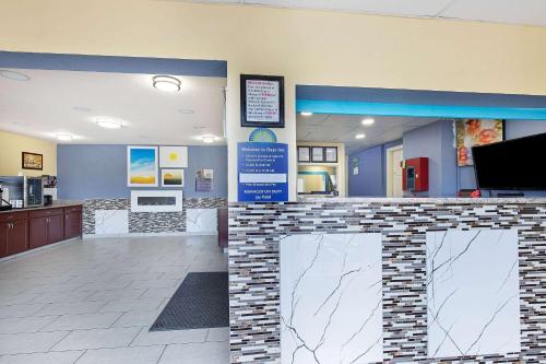 a fast food restaurant with a counter in a store at Days Inn by Wyndham Holladay in Holladay