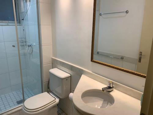 a bathroom with a toilet and a sink and a mirror at Loft completo, Centro Historico 706 in Porto Alegre