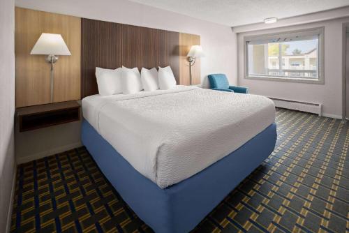 A bed or beds in a room at Days Inn by Wyndham Tonawanda/Buffalo