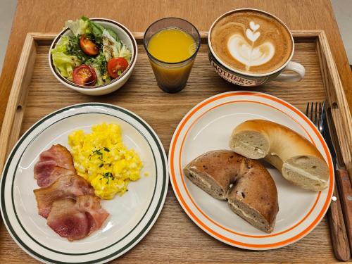 a tray with plates of breakfast food and a cup of coffee at Hotel Vert in Seoul