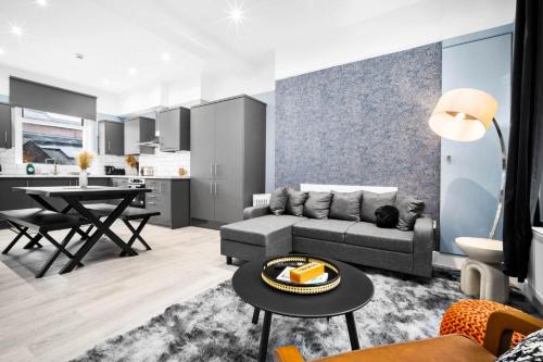 a living room with a couch and a table at The Town Haus By Homebay in Northampton