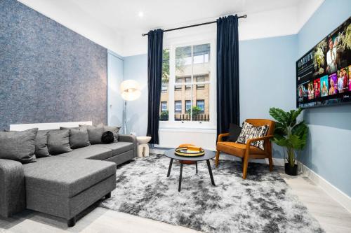 a living room with a couch and a table at The Town Haus By Homebay in Northampton