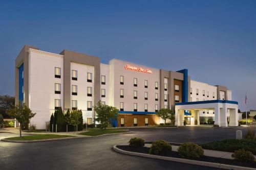 a large white building with a parking lot at Hampton Inn & Suites York South in York