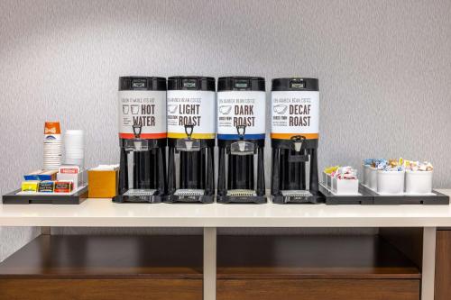 a shelf with four energy bottles on a table at Hampton Inn Atlanta-Georgia Tech-Downtown in Atlanta