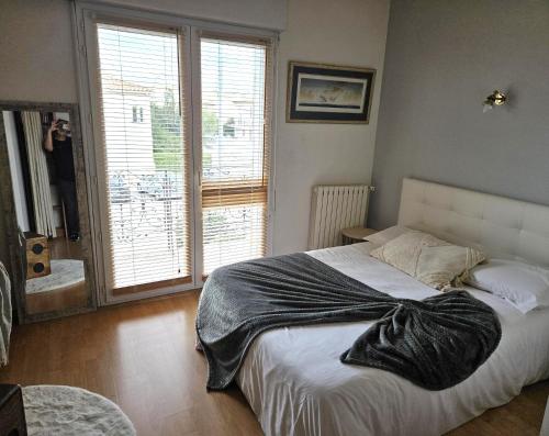 a person taking a picture of a bed in a bedroom at Villa Mars YourHostHelper in Narbonne