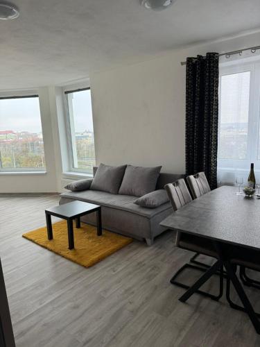 a living room with a couch and a table at Sky Apartments 506 in Plzeň