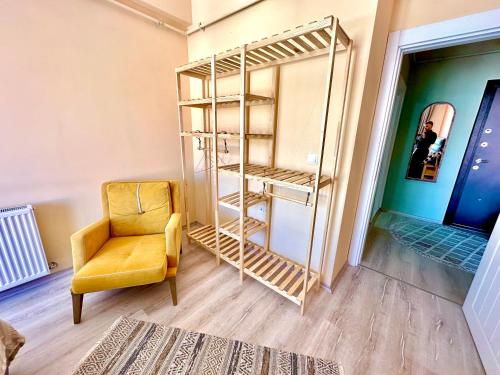 a room with a chair and a book shelf at Modern and Chic Downtown House in Kars
