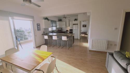 a living room and kitchen with a table and chairs at STAY Mystique Apartment in Limassol