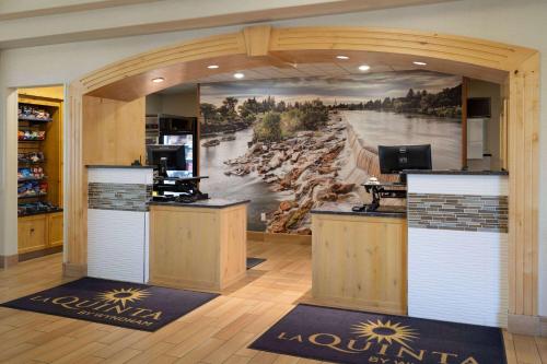 an office with a large painting of a river at La Quinta by Wyndham Idaho Falls/Ammon in Idaho Falls