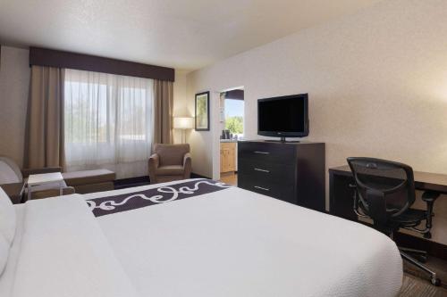 a hotel room with a bed and a flat screen tv at La Quinta by Wyndham Idaho Falls/Ammon in Idaho Falls