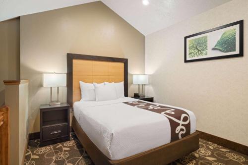 a hotel room with a bed and two lamps at La Quinta by Wyndham Idaho Falls/Ammon in Idaho Falls