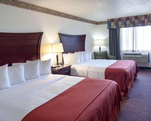 a hotel room with two beds and a window at Quality Inn Midland South in Midland