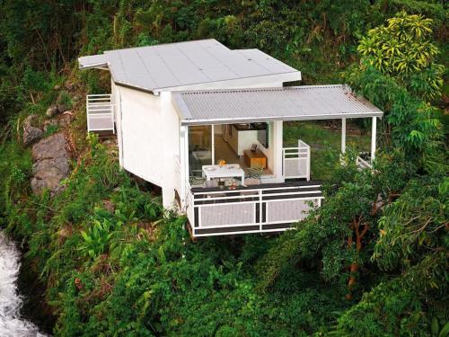 an aerial view of a tiny house on a hill at "La Ravine" privé, luxe, avec une vue unique in Saint-Joseph