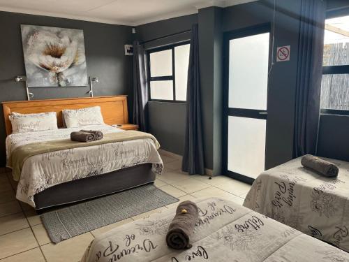 a bedroom with two beds with writing on the walls at La Belle Guesthouse Parys in Parys
