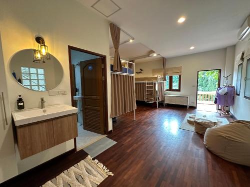 a large bathroom with a sink and a mirror at Blessings in Haad Pleayleam