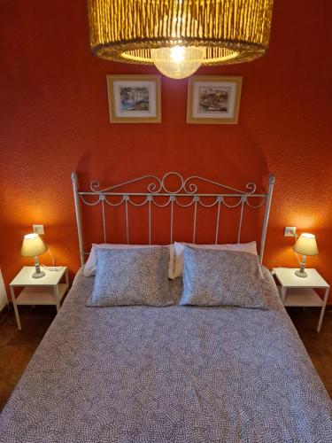 a bedroom with a large bed with two lamps at Aptm Dayma Sierra junto al río Majaceite. in Benamahoma