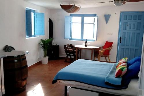a bedroom with a bed and a table and window at The Vine Studio in Rubite