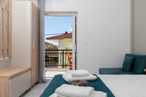 a bedroom with a bed and a balcony at Gramatiki House in Neos Marmaras