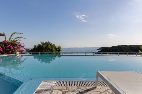 a large swimming pool with a view of the ocean at Costa Smeralda in Sivota