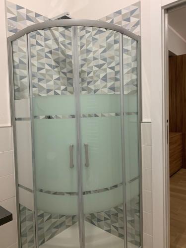 uma cabina de duche em vidro num quarto com uma parede em GRAMSCI 2 rooms em Bolonha