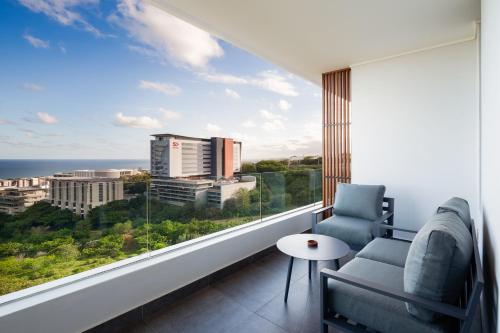 a room with a large window with a view of the city at The Tyne Luxury Apartments in Durban