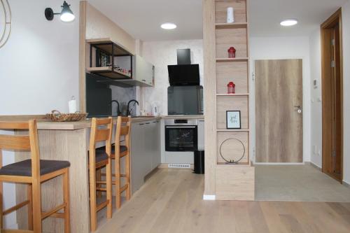a kitchen with a counter and a kitchen with a bar at Ski Mont Apartment Jahorina in Jahorina