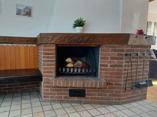 a brick fireplace with food inside of it at Ferienwohnung am Hügel in Schmallenberg