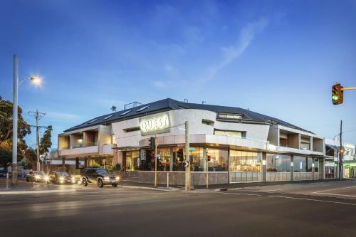 a building on the corner of a street with a traffic light at Quest Brighton on the Bay in Melbourne