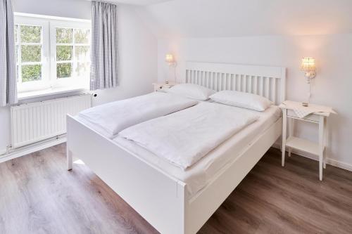 Katil atau katil-katil dalam bilik di Ferienhaus Stürsholz Gut Oestergaard