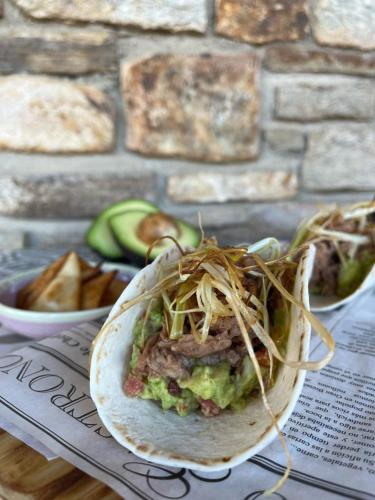 a wrap with meat and vegetables on a table at Casa Rural Fuente del Arca Montejo in Montejo de la Sierra