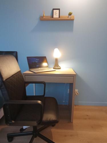 a desk with a laptop computer on top of it at Le Beau Refuge Parisien de Cergy - Parisian modern flat at Cergy in Cergy